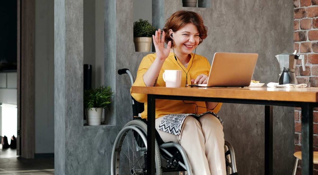 woman in wheelchair participating in an online video meeting, embracing the power of remote online notarization